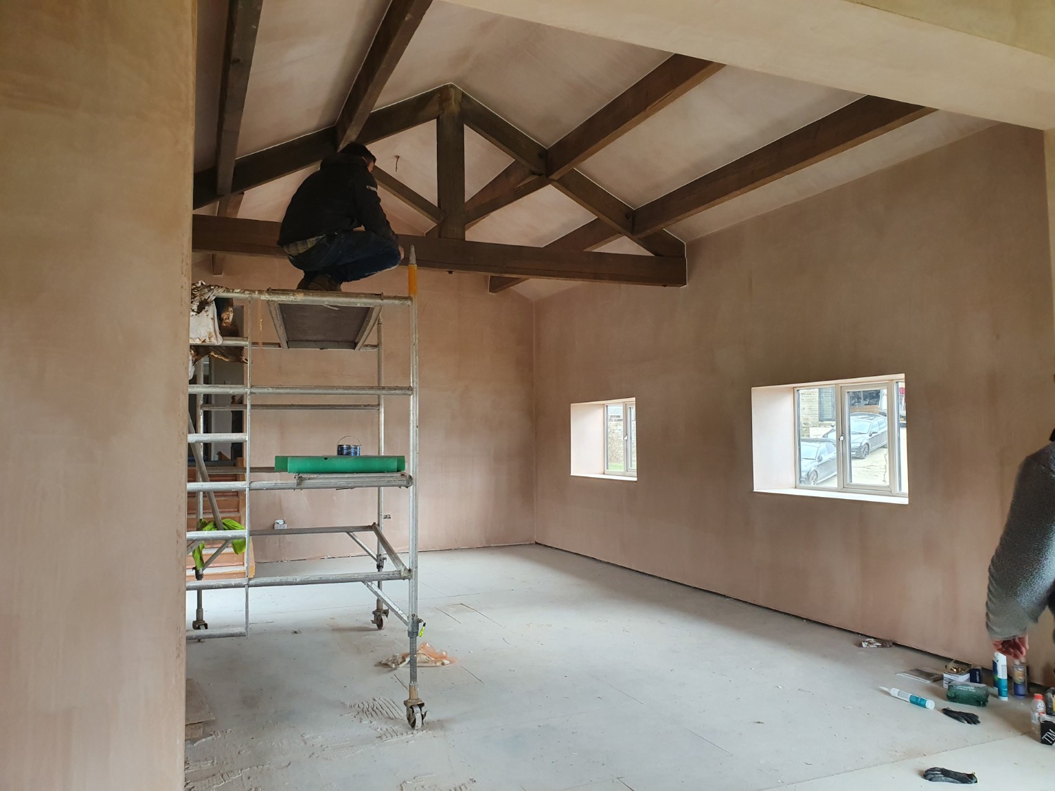 Finished plaster around exposed beams